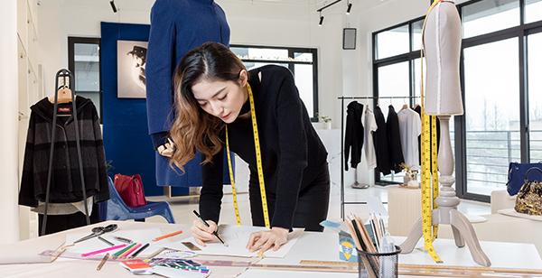 a woman with a measuring tape on her neck writing on a paper